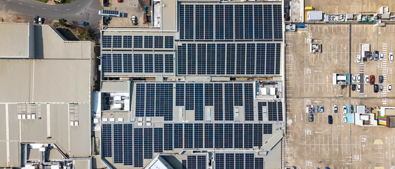 The Shelly Centre roof from directly above, covered in rows of solar modules, between a neighbouring roof and the rooftop car park